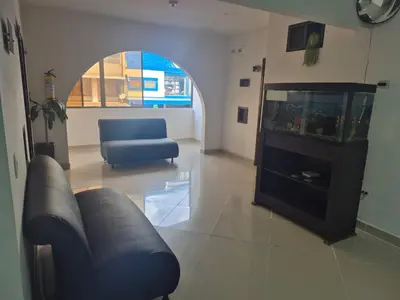 a living room with a couch and a fish tank at hotel universo plaza in Medellín