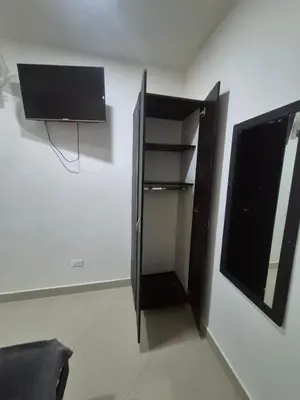a black refrigerator in a room with a window at hotel universo plaza in Medellín