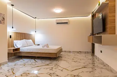 a bedroom with a bed and a flat screen tv at apartaloft laureles 70 in Medellín