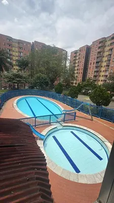 a group of three swimming pools with tall buildings at Camino de los Vientos in Bello