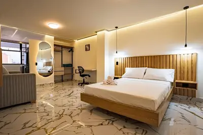 a hotel room with a bed and a desk at prime loft 72 laureles in Medellín
