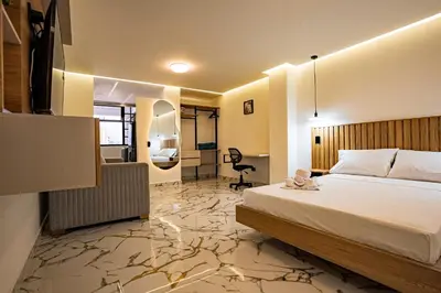 a hotel room with a bed and a desk at prime loft 72 laureles in Medellín