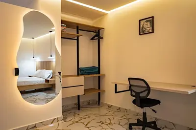 a room with a bed and a desk and a chair at prime loft 72 laureles in Medellín