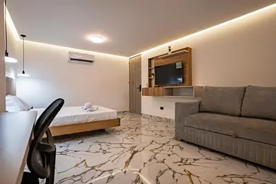a hotel room with a couch and a television at prime loft 72 laureles in Medellín