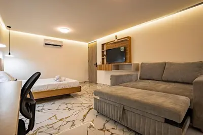 a hotel room with a couch and a tv at prime loft 72 laureles in Medellín