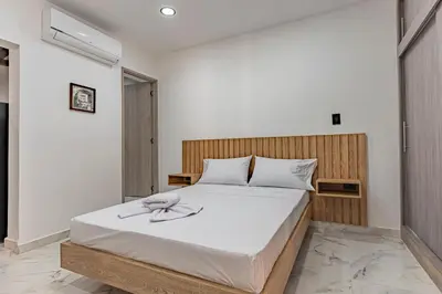 a bedroom with a white bed with a flower on it at Fountain Loft 72 in Medellín