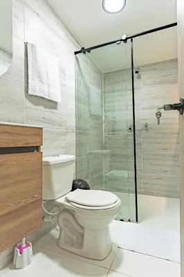a bathroom with a toilet and a glass shower at Fountain Loft 72 in Medellín