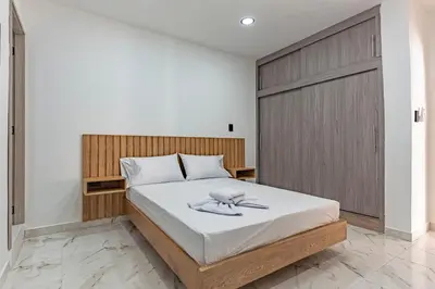 a bedroom with a bed with a wooden headboard at Fountain Loft 72 in Medellín