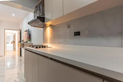a kitchen with a white counter and a stove at Fountain Loft 72 in Medellín