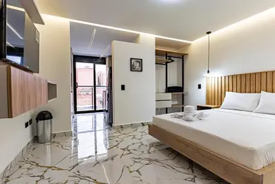 a bedroom with a large bed with a marble floor at Apartaloft exclusivo en laureles in Medellín