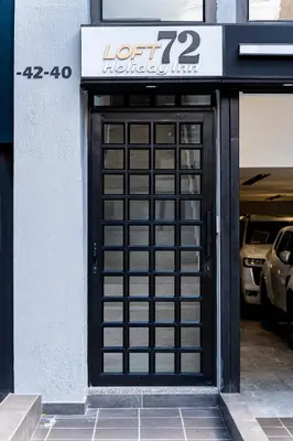 a black door with a sign on a building at Apartaloft exclusivo en laureles in Medellín