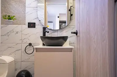 a bathroom with a sink and a mirror at Apartaloft exclusivo en laureles in Medellín