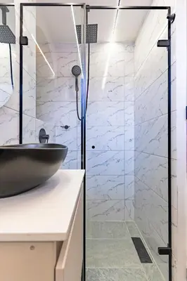 a bathroom with a black sink and a glass shower at Apartaloft exclusivo en laureles in Medellín
