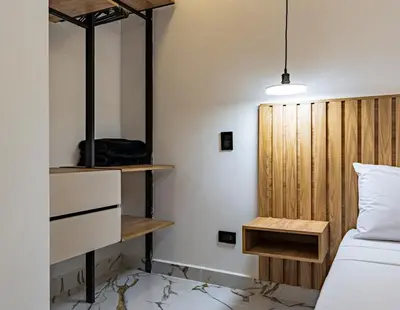 a bedroom with a bed and a wooden headboard at Apartaloft exclusivo en laureles in Medellín