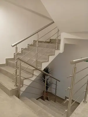 a staircase with a metal railing and a plant at Exclusivo Urban Loft en Laureles in Medellín