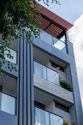 an exterior view of a building with glass windows at Exclusivo Urban Loft en Laureles in Medellín