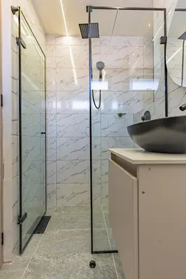 a bathroom with a glass shower and a sink at Exclusivo Urban Loft en Laureles in Medellín