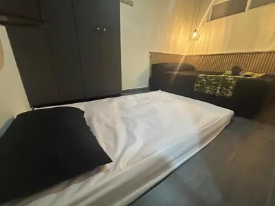 a large white bed in a room with a couch at la pausa 3 Los molinos in Medellín