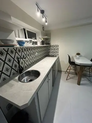 a kitchen with a sink and a table in it at la pausa 3 Los molinos in Medellín