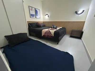 two beds in a small room with two beds at la pausa 3 Los molinos in Medellín