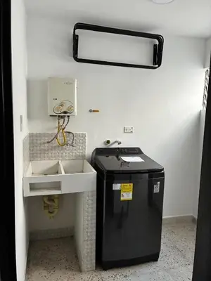 a bathroom with a sink and a trash can at El hospedaje de Ana in Medellín