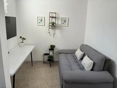 a living room with a couch and a table at El hospedaje de Ana in Medellín