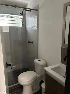 a bathroom with a toilet and a shower and a sink at El hospedaje de Ana in Medellín