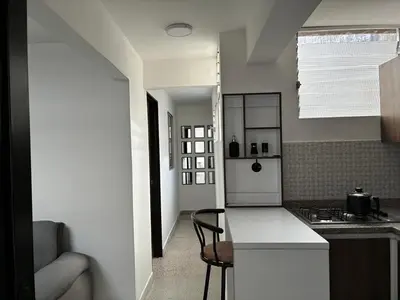 a kitchen with a white counter and a stove at El hospedaje de Ana in Medellín