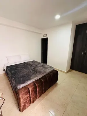 a bedroom with a large bed in a room at Studio apartment in Laureles, ideal central location in Medellín