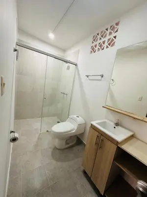 a bathroom with a toilet and a sink and a shower at Studio apartment in Laureles, ideal central location in Medellín