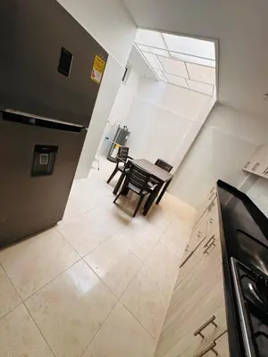 a kitchen and dining room with a table and chairs at Studio apartment in Laureles, ideal central location in Medellín