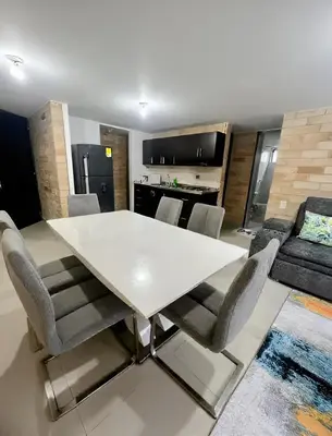 a dining room with a white table and chairs at 2BR Apartment with Skyline View - El Tesoro, El Poblado in Medellín