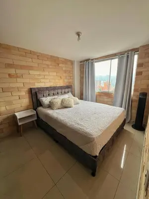 a bedroom with a bed and a large window at 2BR Apartment with Skyline View - El Tesoro, El Poblado in Medellín