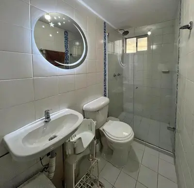 a bathroom with a sink and a toilet and a mirror at 2BR Apartment with Skyline View - El Tesoro, El Poblado in Medellín
