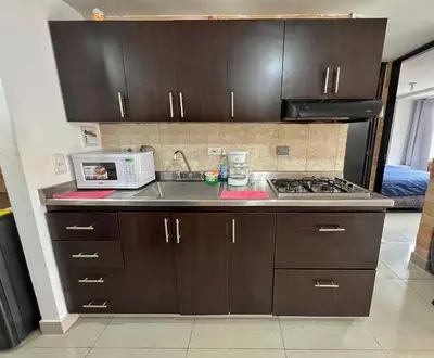 a kitchen with a sink and a microwave at 2BR Apartment with Skyline View - El Tesoro, El Poblado in Medellín