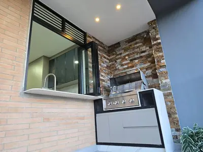 a kitchen with a stove and a window at Exclusivo apartamento en laureles cerca al estadio in Medellín