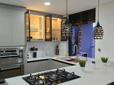 a kitchen with a stove top oven next to a sink at Exclusivo apartamento en laureles cerca al estadio in Medellín
