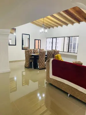 a living room with a couch and a table at Stunning Luxury Penthouse Long term rental only in Medellín