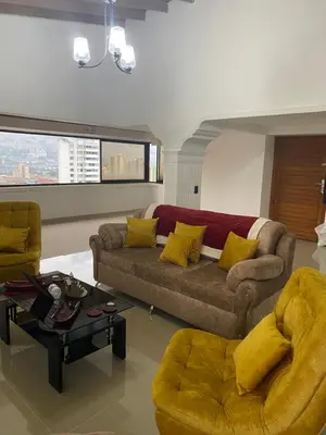 a living room with a couch and two chairs at Stunning Luxury Penthouse Long term rental only in Medellín