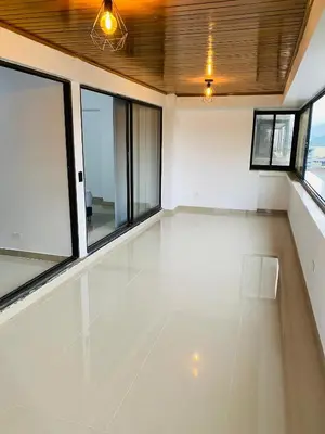 an empty room with windows and a white floor at Stunning Luxury Penthouse Long term rental only in Medellín