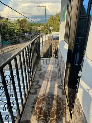 a balcony of a building with a door at Lucena place in La Dorada