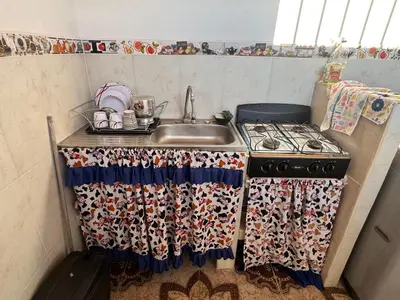 a kitchen with a sink and a stove at Lucena place in La Dorada