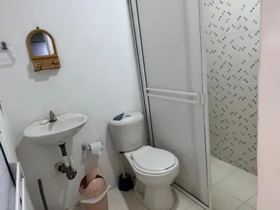 a bathroom with a toilet and a sink and a shower at Lucena place in La Dorada
