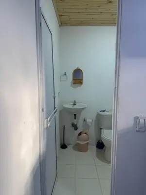 a bathroom with a toilet and a sink at Lucena place in La Dorada