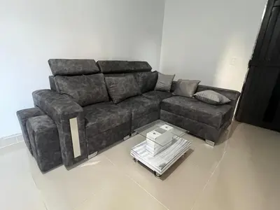 a brown couch in a living room with a table at Hermoso apartamento con excelente ubicación in Medellín