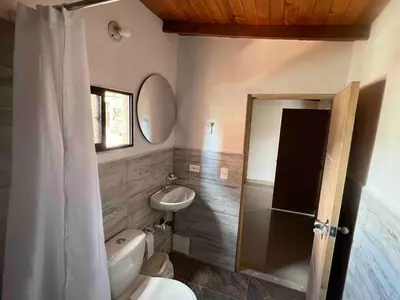 a bathroom with a toilet and a sink and a mirror at Hermoso apartamento con excelente ubicación in Medellín