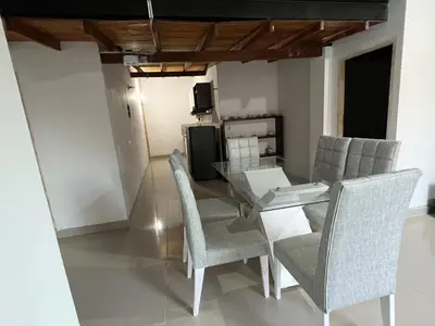 a dining room with a glass table and chairs at Hermoso apartamento con excelente ubicación in Medellín
