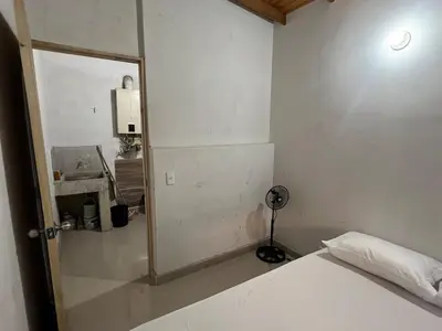 a bedroom with a bed with a mirror and a lamp at Hermoso apartamento con excelente ubicación in Medellín