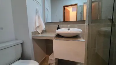 a bathroom with a sink and a toilet and a mirror at ABC-53 Housing in Medellín