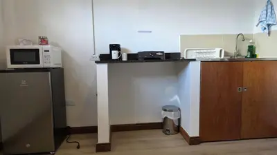 a kitchen with a counter with a microwave and a refrigerator at ABC-53 Housing in Medellín